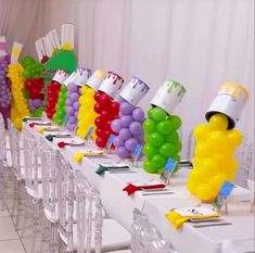 a long table topped with lots of balloons