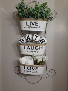 three tiered metal planter with live, love and bath signs on the sides