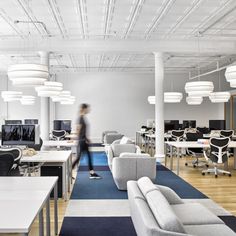 an office filled with lots of desks and chairs