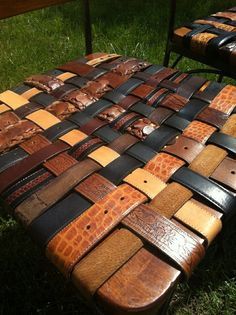 a bench made out of old leathers in the grass