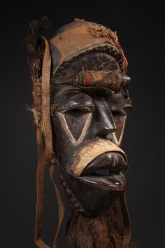 an african mask with feathers on it's head