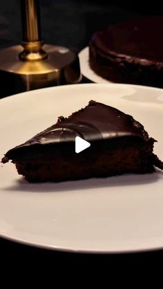 a piece of chocolate cake sitting on top of a white plate