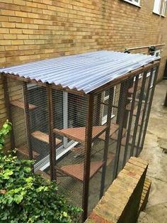 a building with a metal roof next to a brick wall