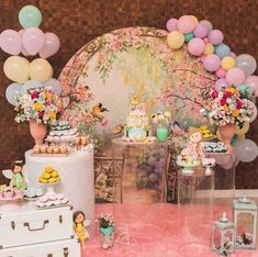 a table filled with lots of cake and balloons