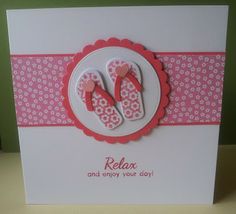 a card with two pairs of pink flip flops sitting on top of a white plate