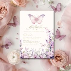 the wedding card is surrounded by pink roses and purple butterfly wings, which are scattered around it