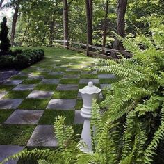 a checkered stone path in the middle of a forest