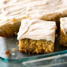 carrot cake with white frosting on a glass plate