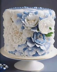 a white and blue cake with flowers on it