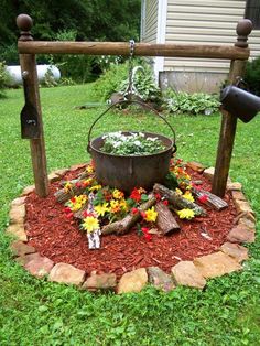 a bucket full of flowers sitting on top of a flower bed