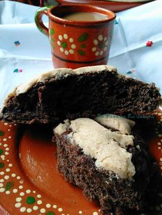 there is a piece of chocolate cake on the plate next to a cup of coffee