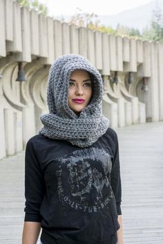 a woman wearing a black shirt and gray scarf