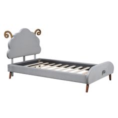 a bed with a cloud shaped headboard and foot board on top of the frame