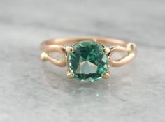 This is a beautiful vintage ring, a solitaire that is as lovely as it is versatile! Simple sweeps of gold grace the shoulders, providing a perfect balance to the gorgeous center stone! We've set a Colombian Emerald in this ring, a bright green gem with unbelievable shine! Incredibly clear and filled with light, this emerald is of exceptional quality, a one of a kind stone from our collection of Colombian gems that we're proud to offer! Metal: 14K Yellow and Rose Gold Gem: Emerald 1.56 Carat Gem Classic Solitaire Diamond Ring For May Birthstone, Classic Solitaire Emerald Promise Ring, Elegant Emerald Ring With Round Band For Promise, Formal Rose Gold Solitaire Emerald Ring, Classic Emerald Ring With Accent Stones, Classic Emerald Ring With Accent Stones And Round Band, Classic Rose Gold Solitaire Emerald Ring, Classic Rose Gold Emerald Ring With Prong Setting, Elegant Emerald Solitaire Ring With Round Band