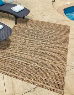 an outdoor area rug next to a swimming pool