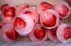 strawberries are frozen in ice cubes and placed on top of each other to cool off