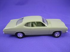 a toy car sitting on top of a purple surface