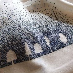 a white shirt with blue dots on it and the word sold written in large letters