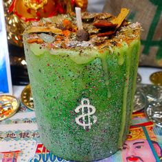 a green drink with sprinkles and a dollar sign on it