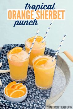 three glasses of orange sherbet punch on a tray