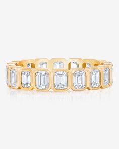 Platinum or 14k solid gold Diamonds: Color: G/H Clarity: VS Classic: Width: 4.2 mm Carat weight per stone: approximately 0.15 each Eternity diamond coverage: Total carat weight: 2.4-3 cttw (ranges depending on finger size) Size 6: 18 diamonds at 2.70 cttw 3/4 diamond coverage: Total carat weight: 1.80-2.25 cttw (ranges depending on finger size) Size 6: 15 diamonds at 2.25 cttw Eternity bands cannot be resized and 3/4 diamond coverage can only be resized 1/4-1/2 size. We recommend ordering this s Gold Diamond Eternity Band With Baguette Cut, Yellow Gold Diamond Eternity Band With Baguette Cut, Luxury Yellow Gold Eternity Band With Bezel Setting, Yellow Gold Cubic Zirconia Baguette Cut Eternity Band, Gold Eternity Band With Prong Setting Baguette Cut, Luxury Gold Eternity Band With Bezel Setting, Gold Cubic Zirconia Eternity Band With Bezel Setting, Gold Baguette Cut Eternity Band With Prong Setting, Yellow Gold Diamond Eternity Band With Bezel Setting