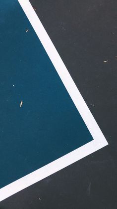 a tennis racket is laying on the ground next to a blue and white line