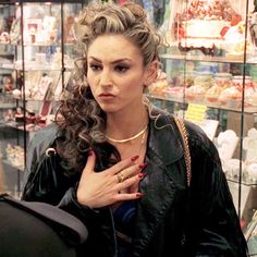 a woman standing in front of a store display