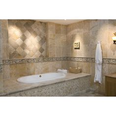 a bath room with a sink and a bath tub next to a mirror on the wall