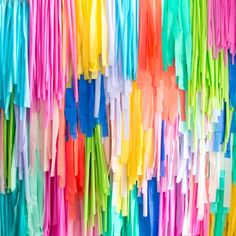 the colorful streamers are hanging on the wall