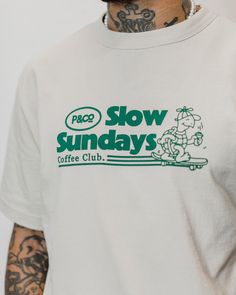 100% soft cotton jersey Mid-weight 220 GSM Hand-drawn graphic Screen-printed Short sleeves[shortcode] [description]The Slow Sunday’s Vol. 2 T-shirt in bone white is a relaxed fit men’s t-shirt made from a mid-weight 100% soft cotton jersey. This classic crewneck features a nostalgic screen-printed front graphic, inspired by our best-selling Slow Sunday’s T-shirt. Part of the Slow Sundays Coffee Club collection.[/description] [fit] Relaxed Fit Delph is 5'11" and wears a size small [/fit][/shortcode] Slow Sundays Coffee Club, Mens White Graphic Tee, Graphic Tee For Men, Hoodie Design Graphic, Screen Printed Tshirt, Retro Graphic Tshirt, Shirt Print Design Graphic Tees, Graphic Tees Design Prints, White Shirt Design