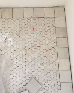 the bathroom floor is being remodeled with tile and grouting on it's sides