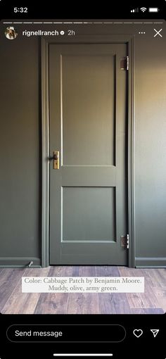 an open door in a room with wood flooring and gray paint on the walls