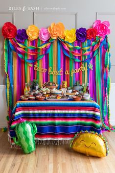 a table with colorful decorations and balloons on it