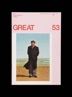 a magazine cover with a man in a black coat and hat on the beach next to the ocean