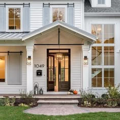 a white house with lots of windows on the front door and steps leading up to it