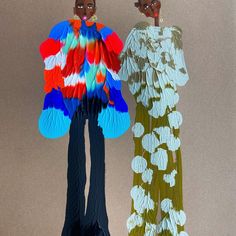 two paper dolls standing next to each other