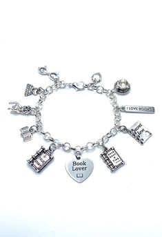 New. This Bracelet makes a perfect gift. Has  11 Book Club Reading Themed Charms all charms are approx 1/2" to 1" in size Stainless Steel bracelet has a lobster clasp closure and is adjustable measures approx 8" bracelet is Stainless Steel  charms are silver tone alloy and steel. (Nickel and lead free) Charms include Reading glasses, I love books, Reading Chair, open Book, A True Story Book, Book Lover,  Once Upon A Time Book, Secret Love, I Love Books small heart Nickel-free Themed Charm Bracelet As Gift, Themed Nickel-free Charms For Gifts, Book Bracelets, Book Charm Bracelet, Once Upon A Time Book, True Story Books, Book Club Reads, Bracelet Love, Love Books