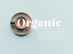 an overhead view of a cup of coffee with the word organic on it, in front of a blue background