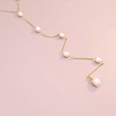 Our handmade Lariat Pearl Necklace is a masterpiece of artistry, combining 14k gold-filled beauty with lustrous freshwater pearls. Choose this necklace to add a touch of sophistication and a dash of nature's elegance to your collection. Handmade in USA. DETAILS: Material: 14/20 gold-filled, Skin Friendly Dimensions: Length 16" plus 2" extender chain, 8" drop Note: As each piece is totally handcrafted and made with natural pearl, dimensions and shapes can slightly vary ensuring no two are exactly Delicate Lariat Drop Necklace With Pearl, Delicate Pearl Drop Lariat Necklace, Baroque Pearl Lariat Necklace With Pearl Charm, Lariat Baroque Pearl Drop Jewelry, Baroque Pearl Drop Lariat Jewelry, Baroque Pearl Lariat With Pearl Drop, Pearl Pendant Lariat Backdrop Necklace, Delicate Pearl Chain Lariat Jewelry, Delicate Pearl Lariat Necklace With Pendant