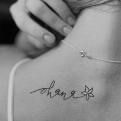 the back of a woman's neck with her name written on it