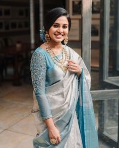 a woman wearing a blue and white sari