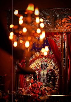 a shrine with candles and flowers on it