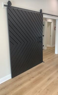 an empty room with a sliding door and hard wood flooring on the side wall