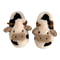 a pair of slippers with a cow face on them