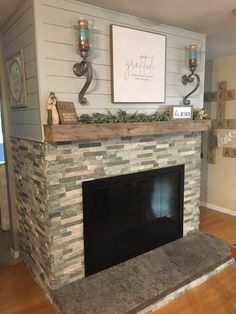 a living room with a fire place and pictures on the wall above it's mantle