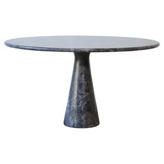 an oval marble table with metal base