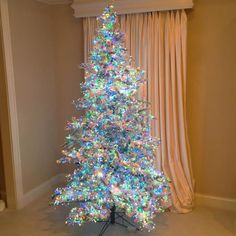 a white christmas tree with multicolored lights