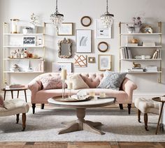 a living room filled with furniture and pictures on the wall