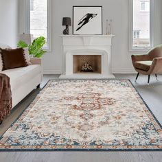 a living room filled with furniture and a rug on top of a hard wood floor