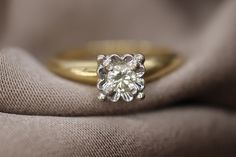 a diamond ring sitting on top of a cloth